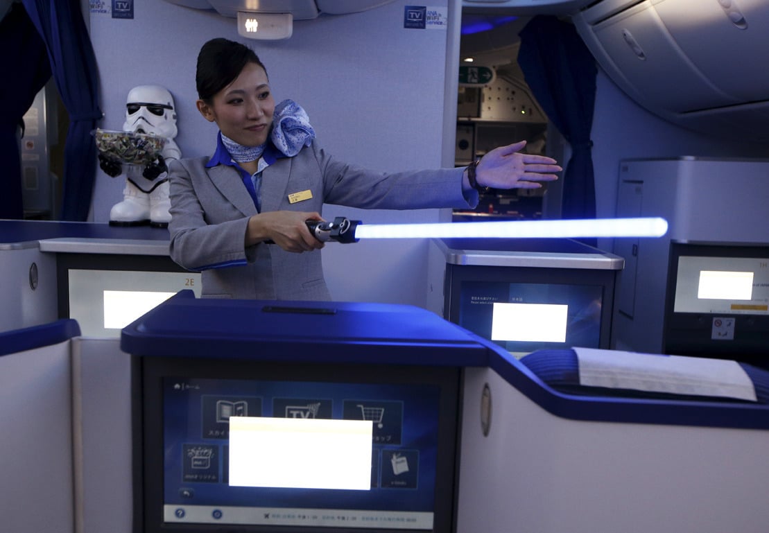 Image #: 40769587 A stewardess holding a lightsabre explains the features of the business class section during a tour of the Star Wars themed All Nippon Airways ANA R2D2 Boeing 787 Dreamliner aircraft at Singapore's Changi Airport November 12, 2015. The aircraft was opened to the media on Thursday as it makes its first Asian stop outside Japan. REUTERS/Edgar Su /LANDOV